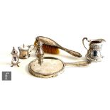 Five items of hallmarked silver to include an Art Nouveau cream jug decorated with stylised