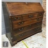 A George IV mahogany fall-front bureau, fitted with an arrangement of pigeon holes, eight small