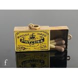 A 9ct hallmarked novelty charm modelled as a box of British Made matches with yellow and black