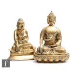 Two Chinese polished cast metal Buddha figures, each modelled wearing robes and seated in lotus