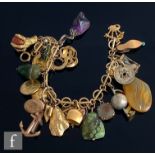 A 9ct fancy link bracelet with several charms suspended to include a gilt Australian sixpence, stone