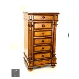 A late 19th Century French walnut night cabinet, the inverted breakfront top above a single