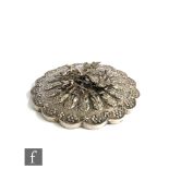 An early 20th Century Turkish silver backed circular hand mirror decorated with a central peacock