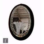 A large 19th Century Stourbridge crystal glass girondale wall mirror with oval mirror backed on a