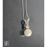 A 9ct hallmarked white gold cultured pearl and diamond set pendant single pearl below a single