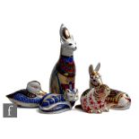 Five assorted Royal Crown Derby paperweights comprising a boxed Royal Cats Egyptian cat (lacking