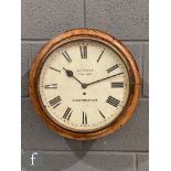 A late 19th Century circular oak cased wall clock with single fusee movement, the painted