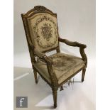 A late 19th to early 20th Century gilt wood fauteuil open armchair, with foliate carved exposed gilt