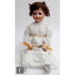 An early 20th Century German bisque socket head doll with sleeping brown eyes, open mouth with