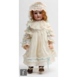 An unmarked bisque socket head doll, with sleeping brown eyes, open mouth with teeth, incised and