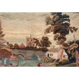 An early 19th Century naïve silkwork picture depicting a river bridge and village church, framed,