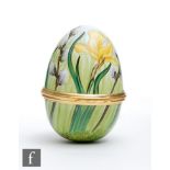 A Moorcroft Enamels egg shaped trinket box and cover decorated with hand painted daffodil and