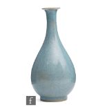 A Chinese Guan type bottle vase, the glaze foot gently rising to a swollen body, with tapered neck