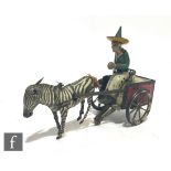 A 1920s Lehmann 752 Zikra clockwork tinplate zebra and cart, seated driver in red cart, integral