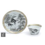 A Chinese en grisaille painted 18th/19th Century teabowl and saucer, painted with oxen in a