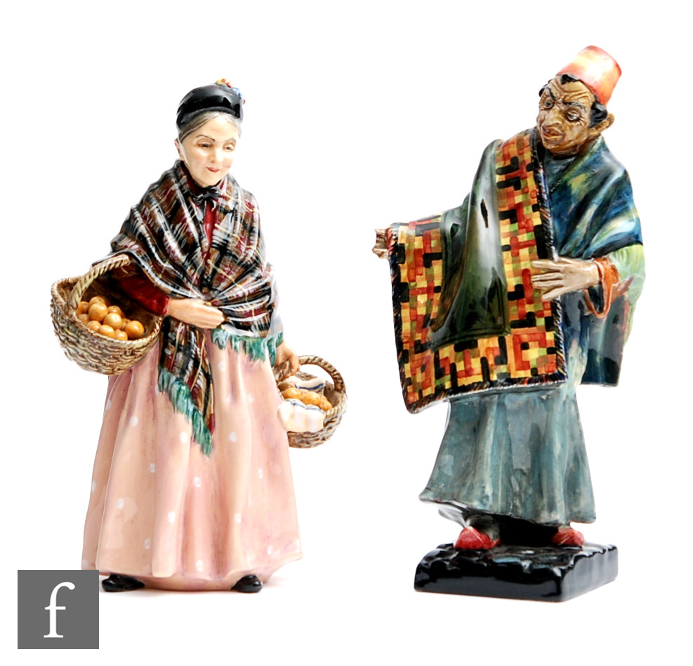 Two Royal Doulton figures comprising The Orange Lady HN1759 and the Carpet Seller HN1464, A/F. (2)