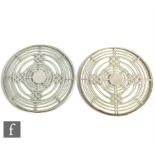 A pair of early 20th Century circular glass teapot stands each with silver overlay geometric