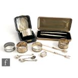 Thirteen items of hallmarked silver to include four napkin rings, a cased pen and pencil, flat