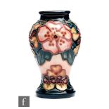 A small Moorcroft Pottery vase decorated in the Oberon pattern designed by Rachel Bishop,