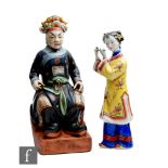 Two Chinese figures depicting a seated official dressed in robes, height 41cm, and a Chinese lady