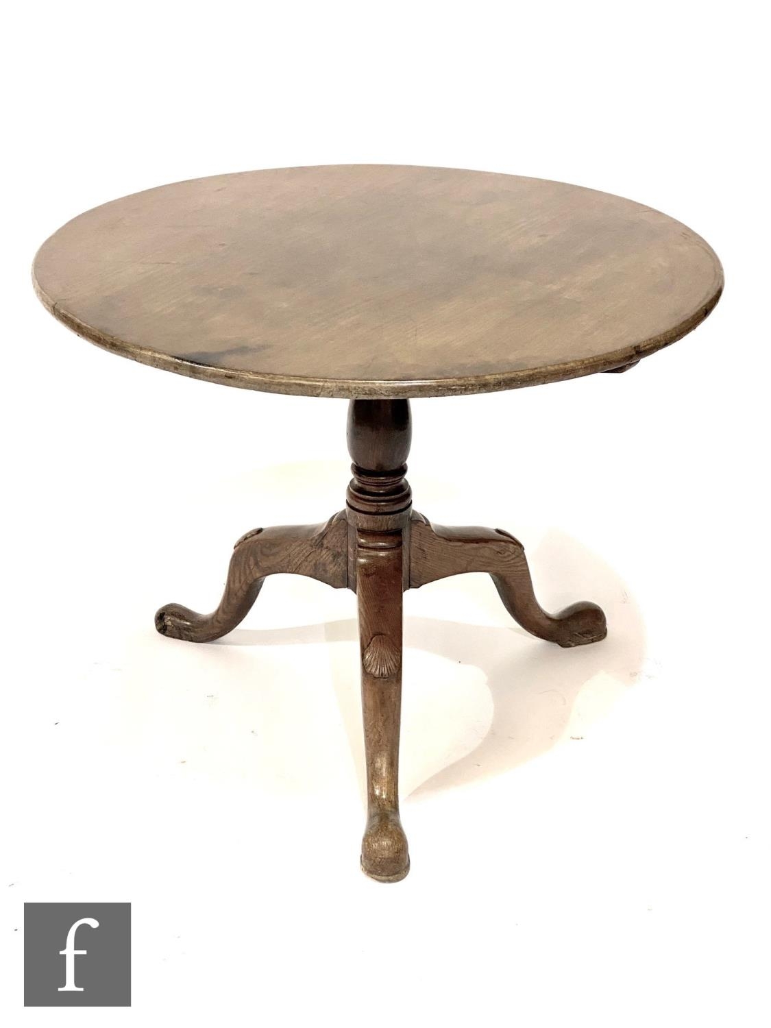 A George III mahogany and oak circular tripod occasional table on turned baluster pedestal, width