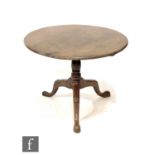 A George III mahogany and oak circular tripod occasional table on turned baluster pedestal, width