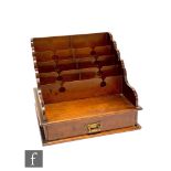 An Edwardian mahogany letter rack with five sectioned rack above a single drawer, height 25cm, width