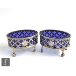 A pair of George III hallmarked silver oval open salts with pierced borders and raised on four