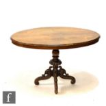 A late Victorian marquetry inlaid oval tilt top breakfast table on turned pedestal and four scroll
