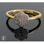 A mid 20th Century 18ct diamond daisy cluster ring, seven stones to a platinum head and knife