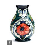A small Moorcroft Pottery vase decorated in the New Poppy pattern designed by Rachel Bishop,