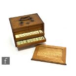 An early 20th Century mahjong case fitted with a graduated set of five drawers, with contents and