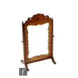 A walnut framed toilet swing mirror in the Georgian style, mounted to an oak stand with applied