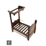 A miniature Victorian style apprentice half tester bed with shaped end and canopy, on turned feet,