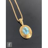 A 9ct hallmarked single stone blue topaz pendant, oval stone within gold mount and suspended from