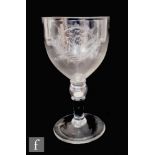 An early 19th Century coin goblet, the ovoid bowl engraved with an oval cartouche with monogram