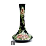 A Moorcroft Pottery vase of compressed globe and shaft form decorated in the Florian Flame pattern