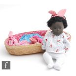 A Trendon Sasha Black Baby doll, height 12 inch, with a selection of associated outfits, Moses