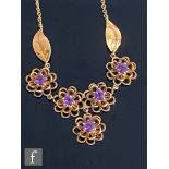 A modern 9ct hallmarked amethyst necklet with five circular stones, each set to a stylised flower