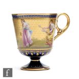 A Vienna type pedestal coffee cup decorated by C. Heer with hand painted classical figures against a