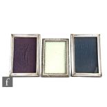 Three hallmarked silver rectangular easel photograph frames, two plain and one with beaded
