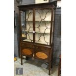 An early 20th Century Chippendale style mahogany side display cabinet, the blind fret-carved