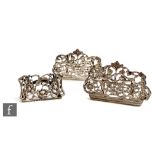 A pair of Victorian hallmarked silver menu holders decorated with cherubs in a foliate setting,