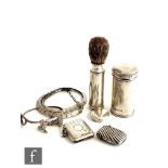 A hallmarked silver travelling shaving brush within two cylindrical silver sleeves, height 8cm,