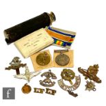 A World War One medal pair to 130430 Drv E.Jones R.A, with various cap badges and a small three