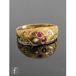 An early 20th Century 18ct ruby and seed pearl ring with gypsy set stones to a floral design, weight