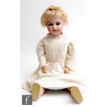 A late 19th Century Simon and Halbig bisque socket head doll, head mould 1079, with sleeping brown