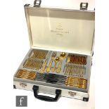 A modern gold plated canteen of cutlery for twelve place settings within an attaché case, model
