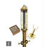 A 20th Century brass marine stick barometer by H D F Y C London, on a Gimbel mount, length 90cm, and