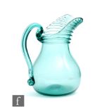 A late 19th Century green glass jug of swollen ovoid form with tapered collar neck and integral